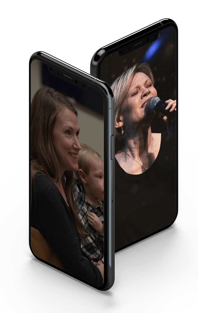 models of iphones displaying pictures of a mother and child and a singer